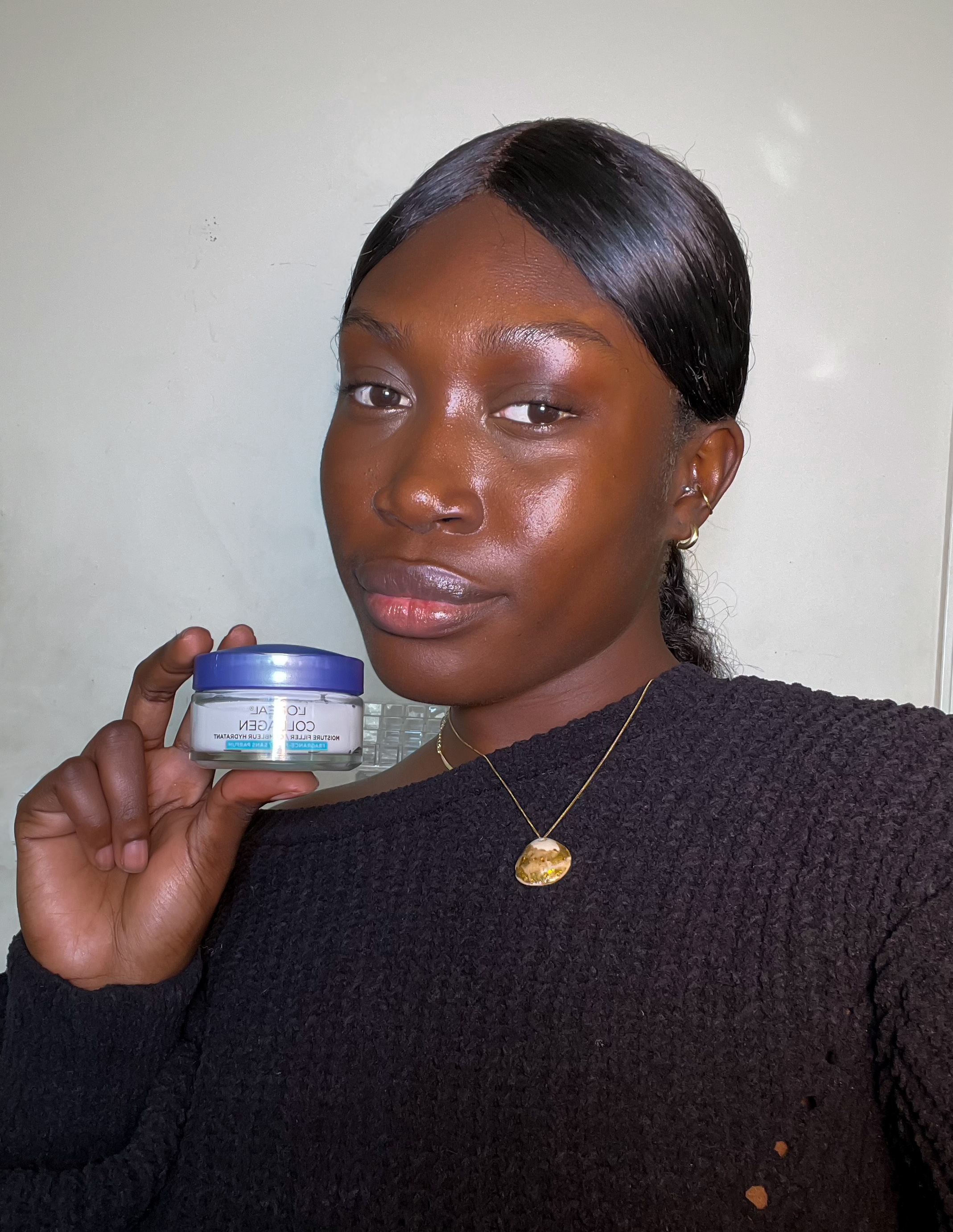 Winter skincare routine; using the L’Oréal collagen moisturizer on dark skin woman