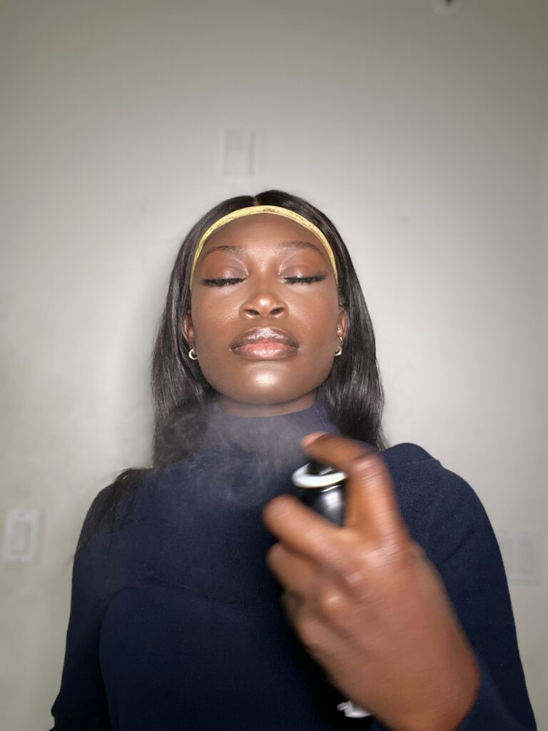 black woman using morphe setting mist for makeup